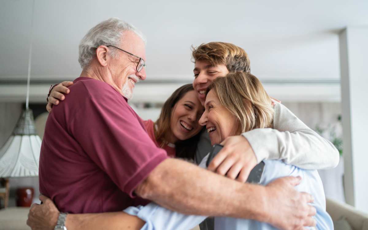 Resident family embracing each other at Cedarwood in Gretna, Louisiana