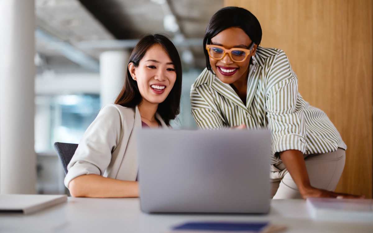 Two Residents looking at a laptop at Banyan Club East in Pompano Beach, Florida