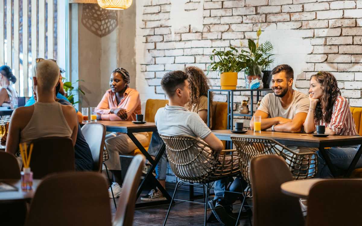 Socializing in modern, stylish cafe setting at 4500 Dewey Ave Apartments in Rochester, New York 