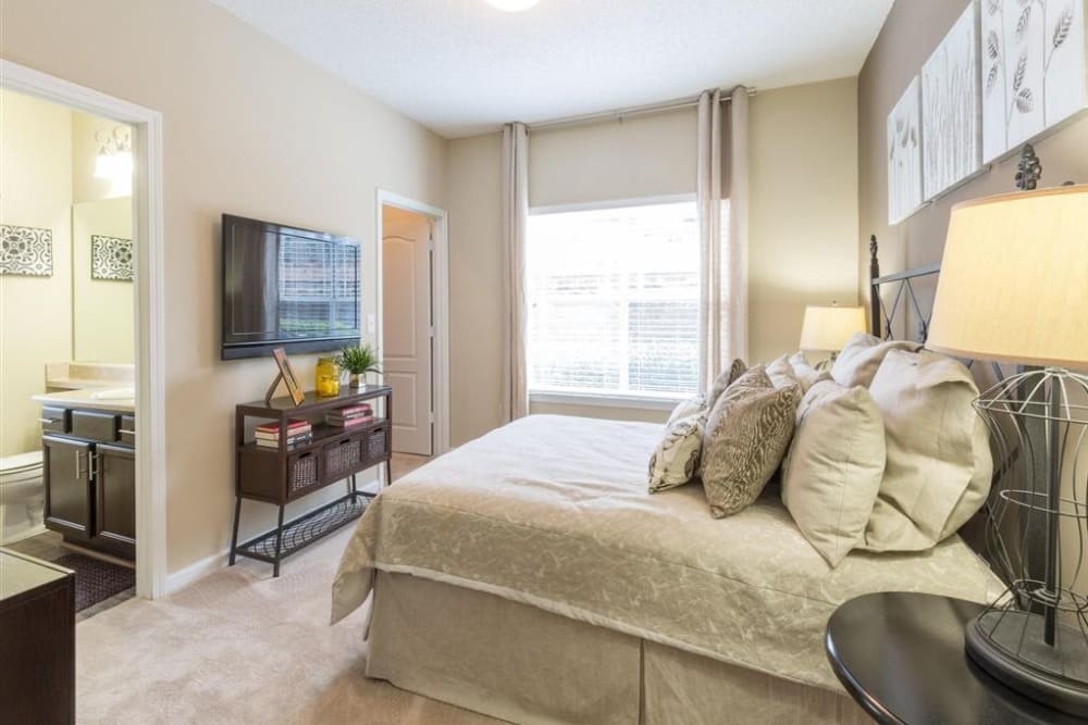 An apartment bedroom with attached bathroom at Chattahoochee Ridge in Atlanta, Georgia