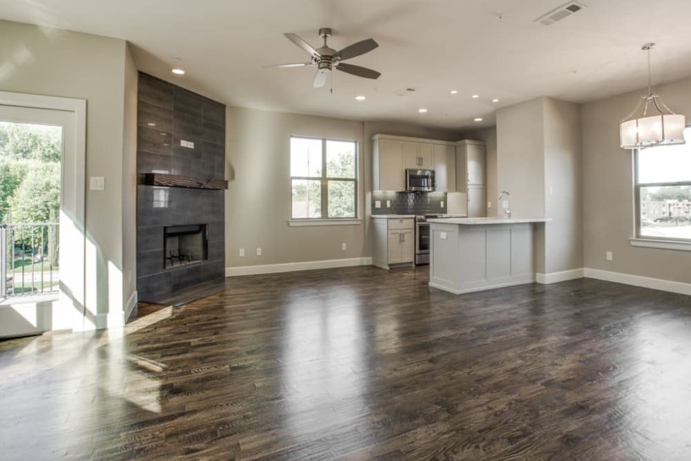 Open concept floor plan of living room and kitchen with hardwood floors at The Collection Townhomes in Dallas, Texas