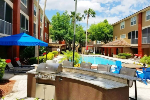Community grill overlooking the swimming pool at Amara at MetroWest in Orlando, Florida