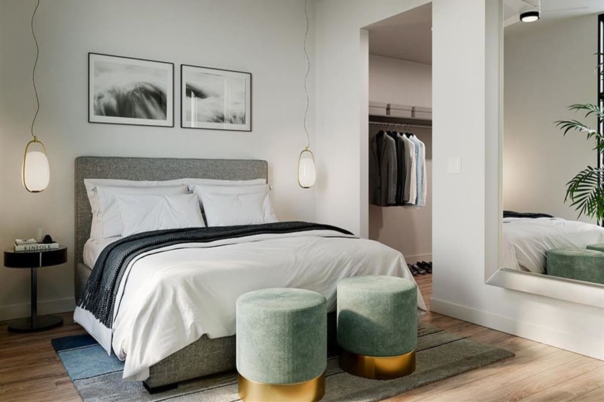 Furnished bedroom with a walk-in closet at S'PARK Apartments in Boulder, Colorado