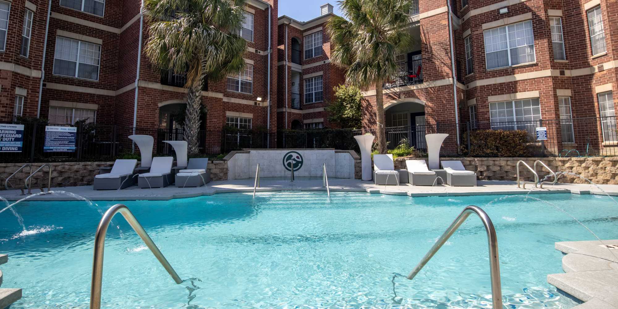 Swimming pool with lounge chairs at Brixton in Round Rock, Texas