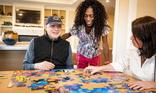 Residents with caregiver playing games at English Meadows in Blacksburg, Virginia