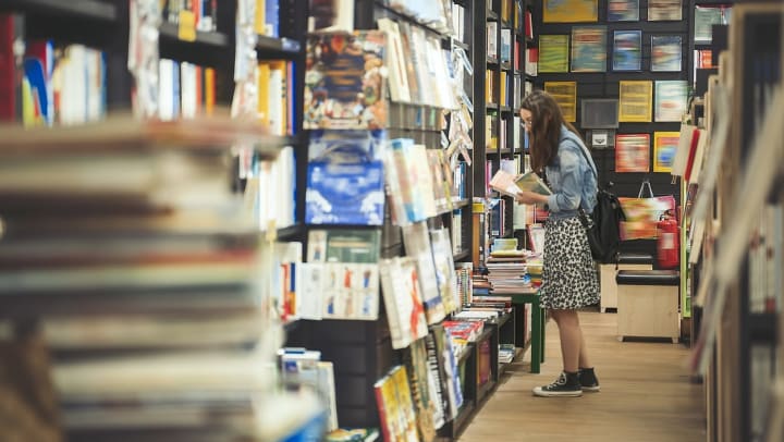 girl browsing books in a bookstore in Albuquerque