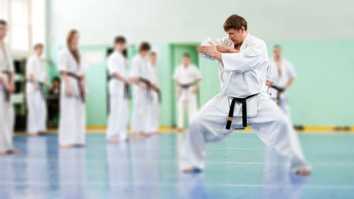 A martial artist practices his form in front of a martial arts class | martial arts studios around Albuquerque