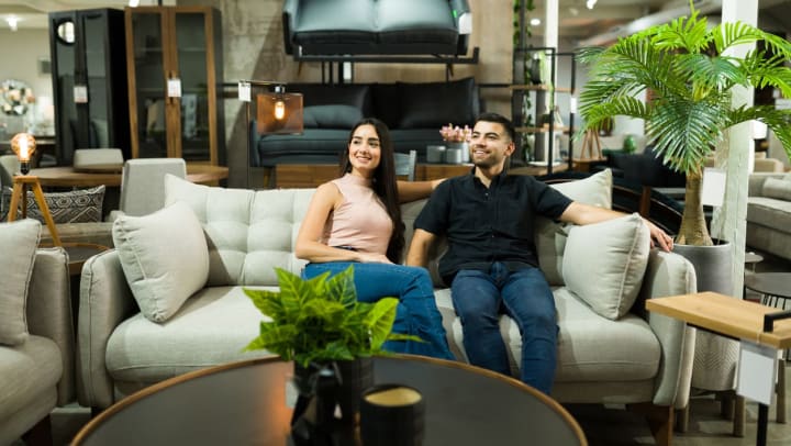 A ﻿couple trying out a modern couch on display in a Durango furniture shop.