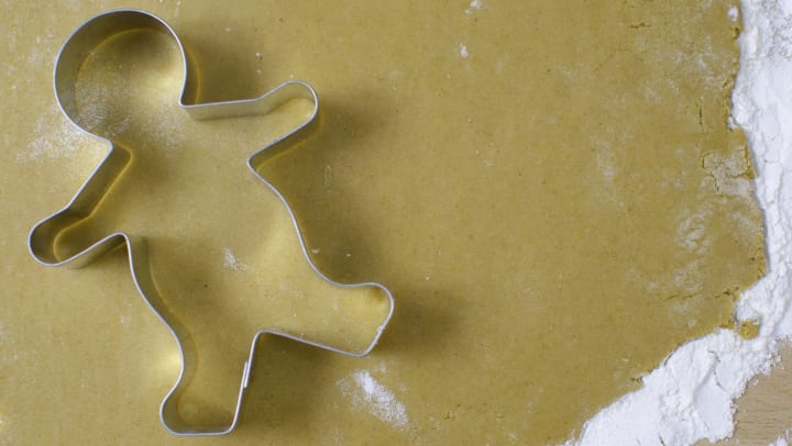 Gingerbread cookie cutter on a rolled out piece of dough