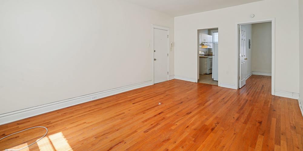 Unfurnished living room with wooden flooring at Central West End Apartments in Saint Louis, Missouri