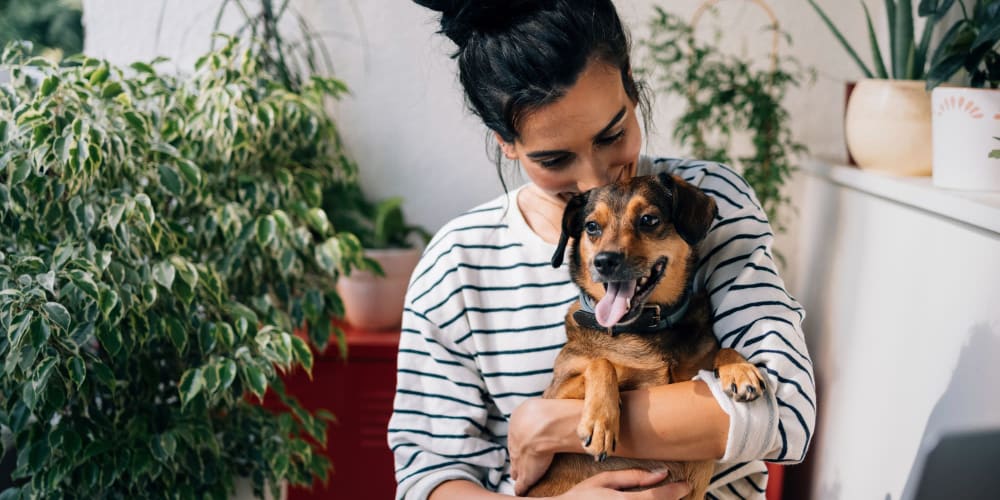 Resident hugging her dog at Tides at Meadowbrook in Fort Worth, Texas