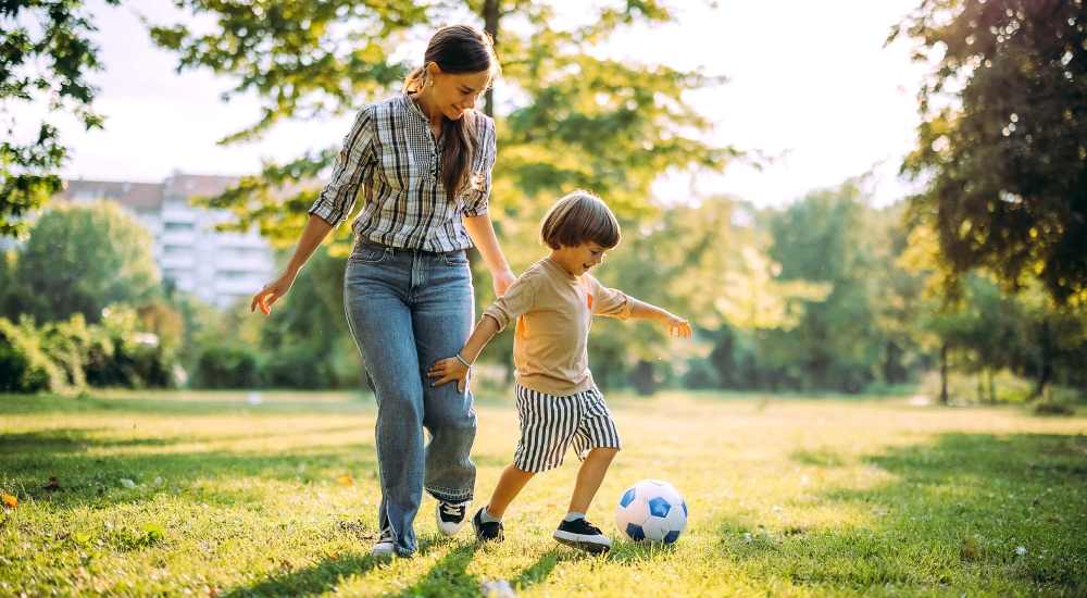 Mother and son playing in a park near Aven Residences in Houston, Texas