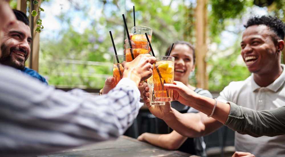Residents having drinks at a restaurant near Main and Mill in Lewisville, Texas