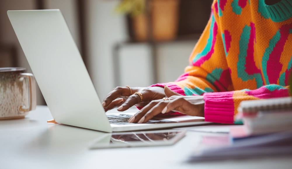 Resident working on her laptop at Maplewood Court in Bridgeport, Connecticut