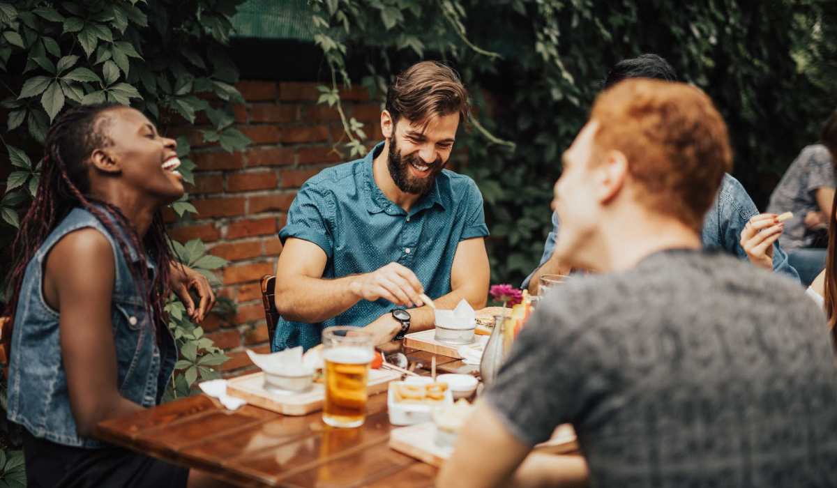 Friends having their favorite food at a restaurant near The Marke Apartment Homes in Santa Ana, California