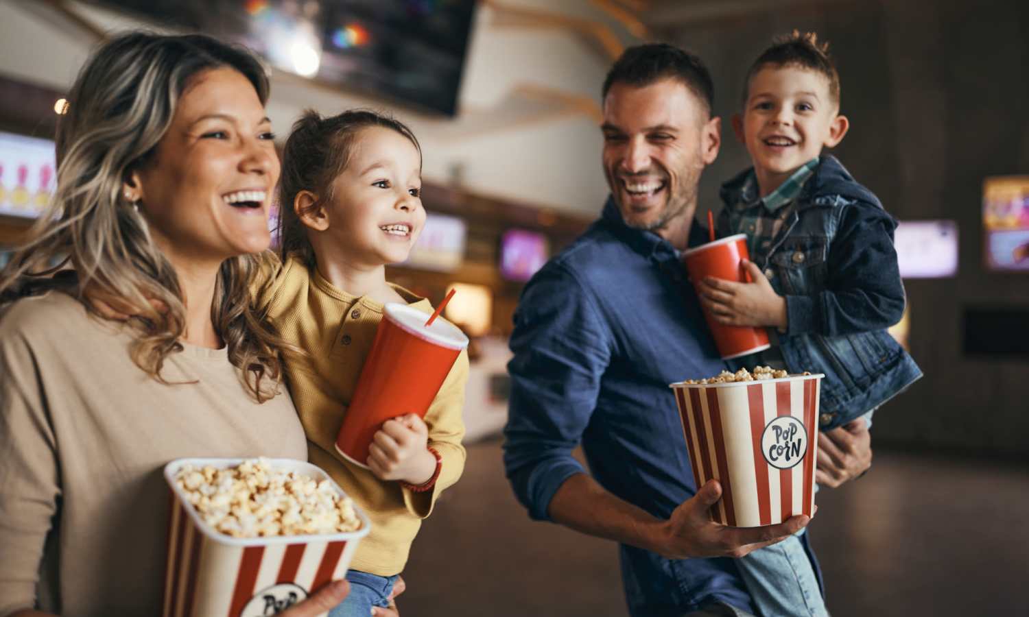 A happy resdient family at a movie theater near Pecan Villa Apartments in Houston, Texas