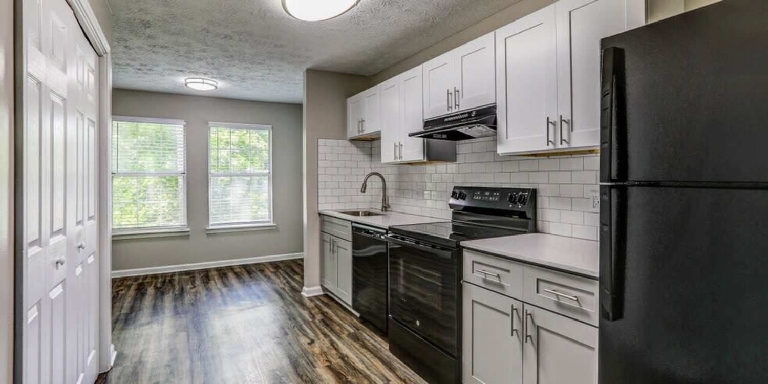Spacious kitchen next to three-seater dining table at Meadow Crossing in Conyers, Georgia