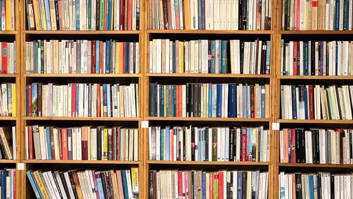 straight-on angle of fully packed bookshelves with brown wood at a library | local library near Ooltewah