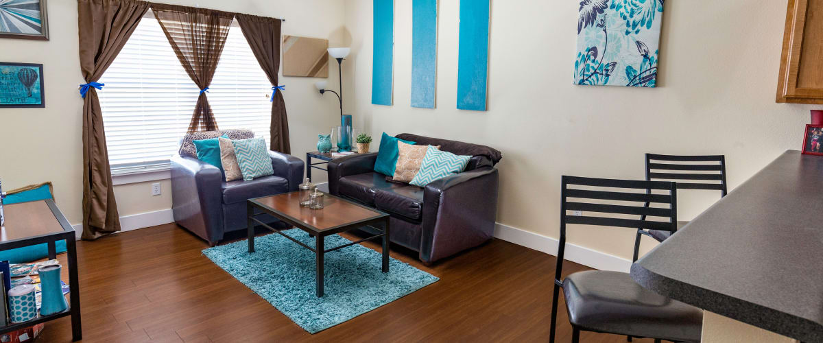 A comfortable living room with a large window at Beacon Springfield in Springfield, Missouri