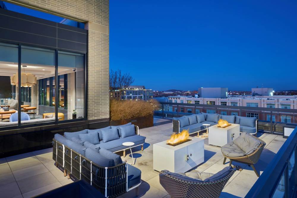 Meridian on First Phase II Roof Deck With Fire Pits at Night