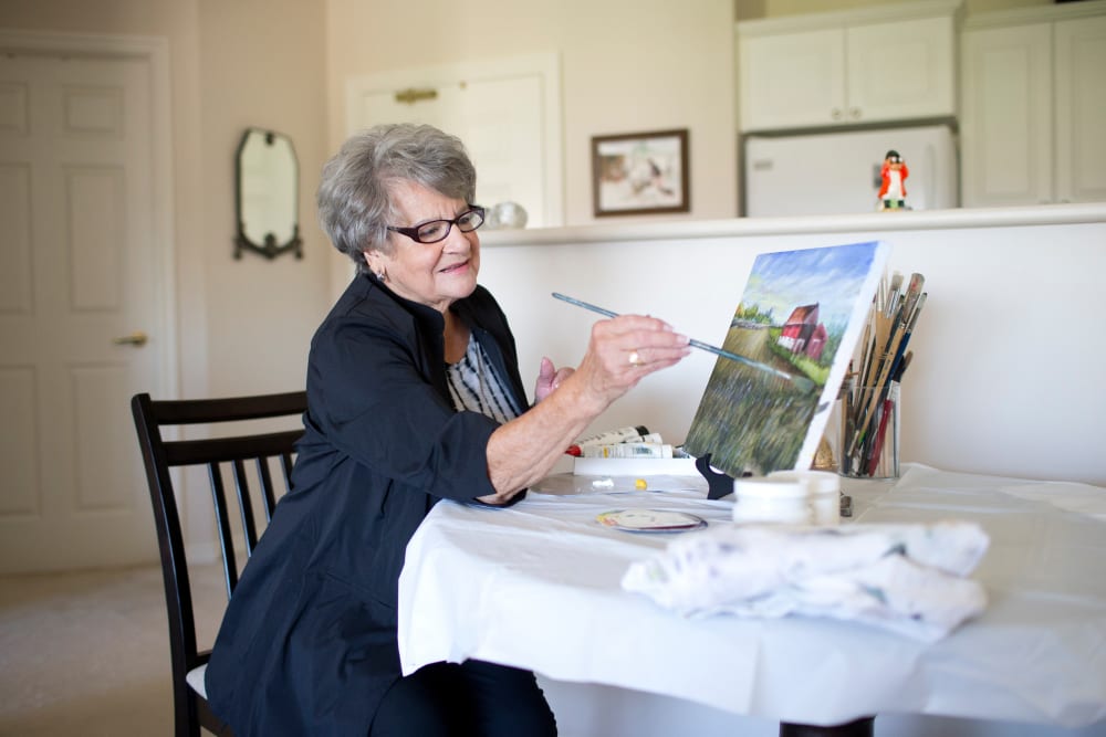 A resident painting in her home at Touchmark at Coffee Creek in Edmond, Oklahoma