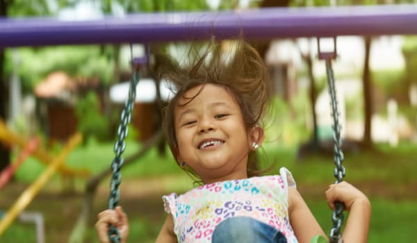 Kid playing in playground at Pinebrook Apartments in Ridgeland, Mississippi