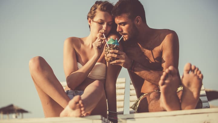 Resident couple sipping a cocktail together at a beach near Olympus at the District in South Jordan, Utah