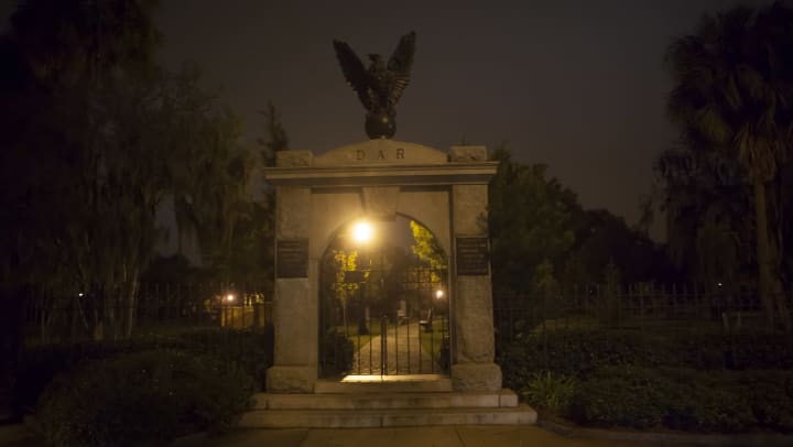 Front entrance to colonial park cemetery at night.