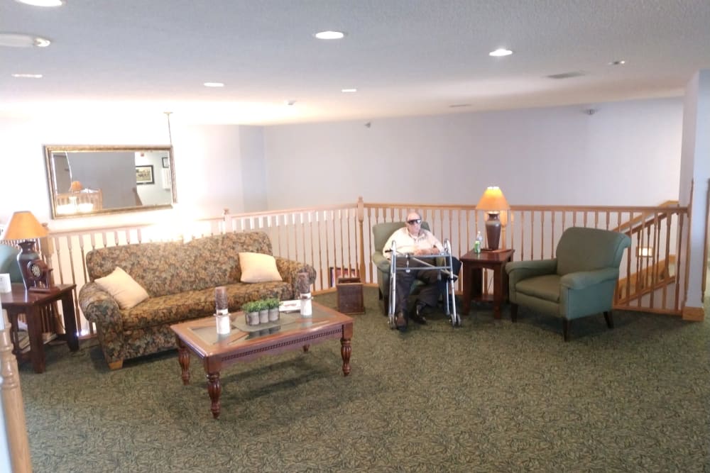 Resident in a sitting area at Whispering Oak Place in Ellendale, Minnesota