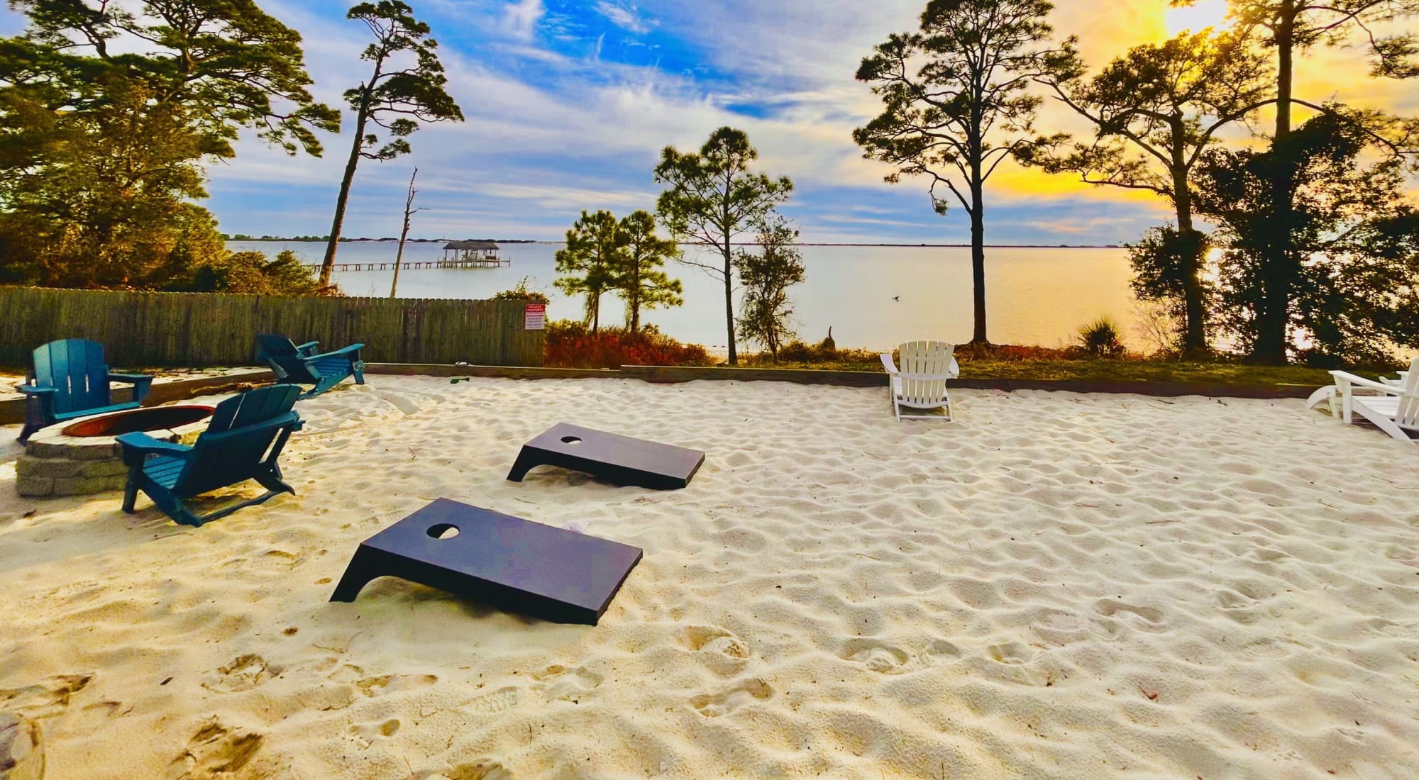 Sandy amenities with cornhole and chairs Amenities at Emerald Shores in Mary Esther, Florida