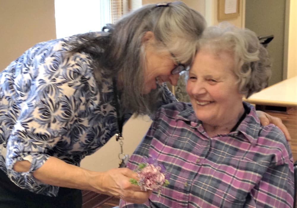 Resident and daughter embracing at Bell Tower Residence Assisted Living in Merrill, Wisconsin