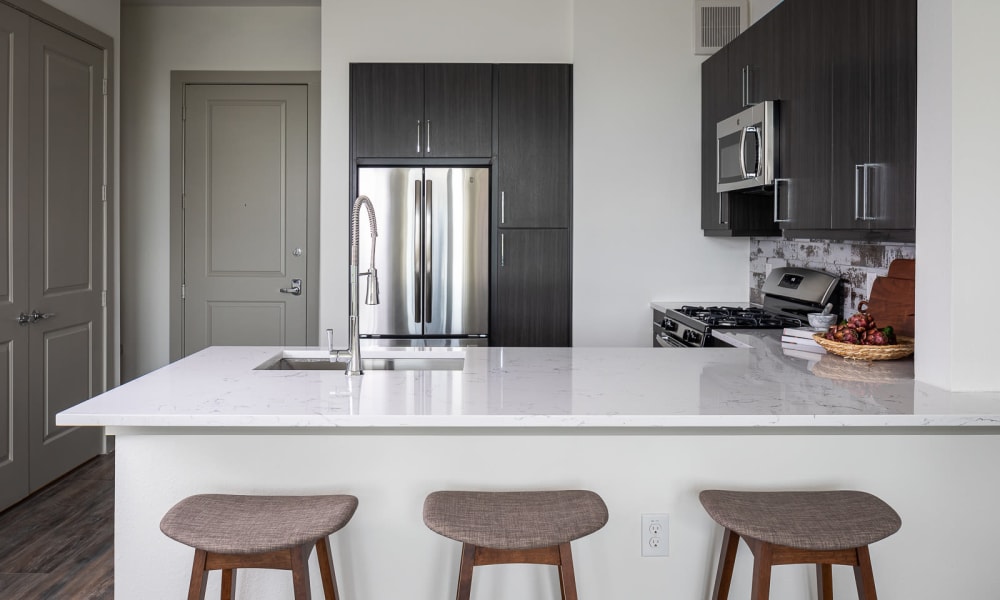 Model kitchen with breakfast bar at Bellrock Summer Street in Houston, Texas