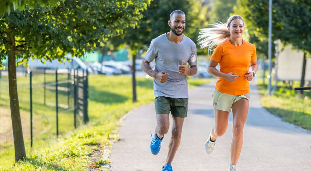 Resident couple jogging in a park near Warrick Trail Apartments in Newburgh, Indiana