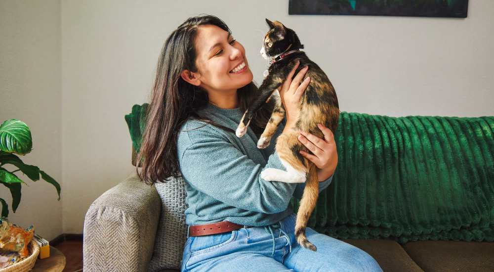 Resident playing with her pet cat at Bonita Ranch in Sylmar, California