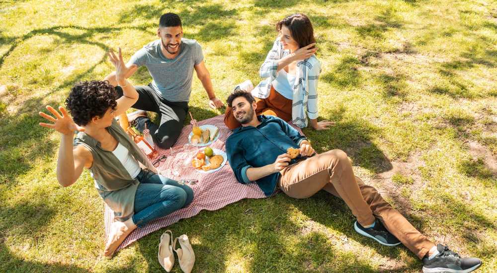Resident friends enjoying in the park near Newland Garden Apartments in Garden Grove, California