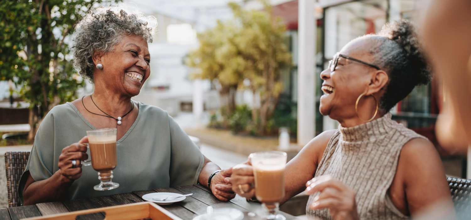 Smiling residents enjoying coffee at Grande Oak III in Williamsburg, Virginia