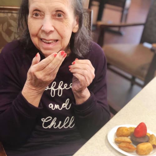 Resident with a plate of desert at Oxford Glen Memory Care at Sachse in Sachse, Texas