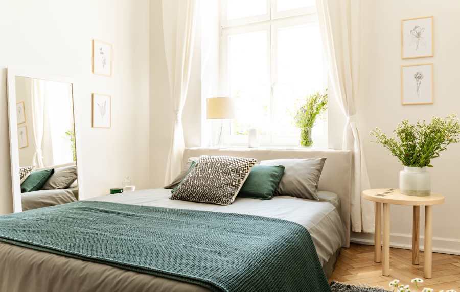Modern bedroom with window at Wasatch Club Apartments in Midvale, Utah