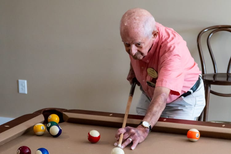 A resident plays pool at Harmony at West Ashley in Charleston, South Carolina