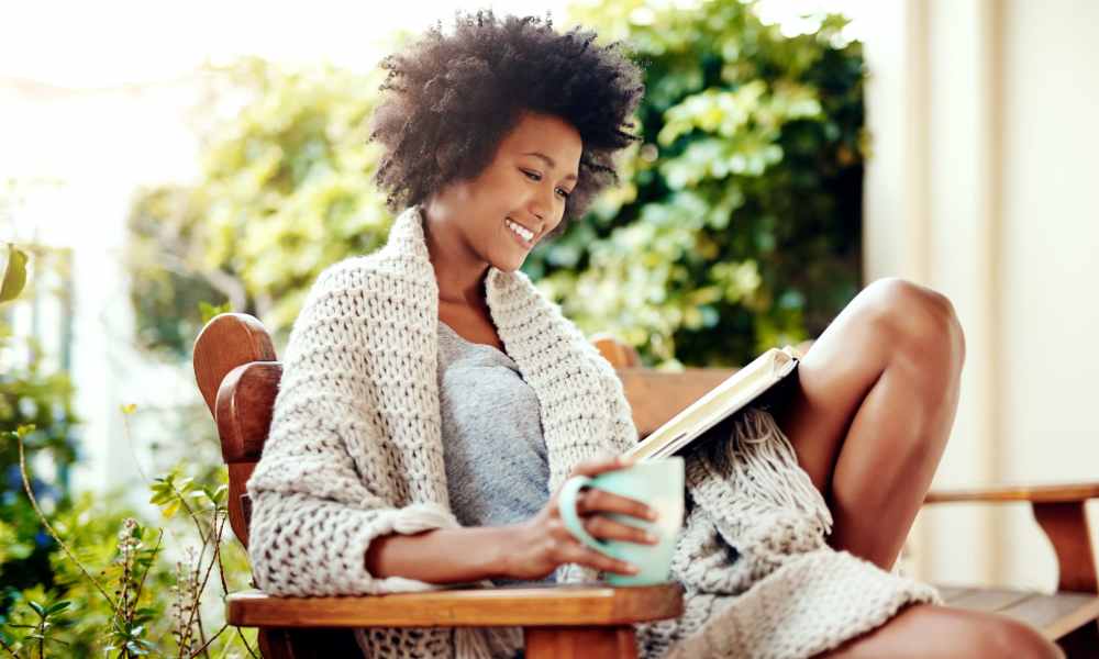 Resident having coffee in her private patio at Crown Villa Apartments in Savannah, Georgia