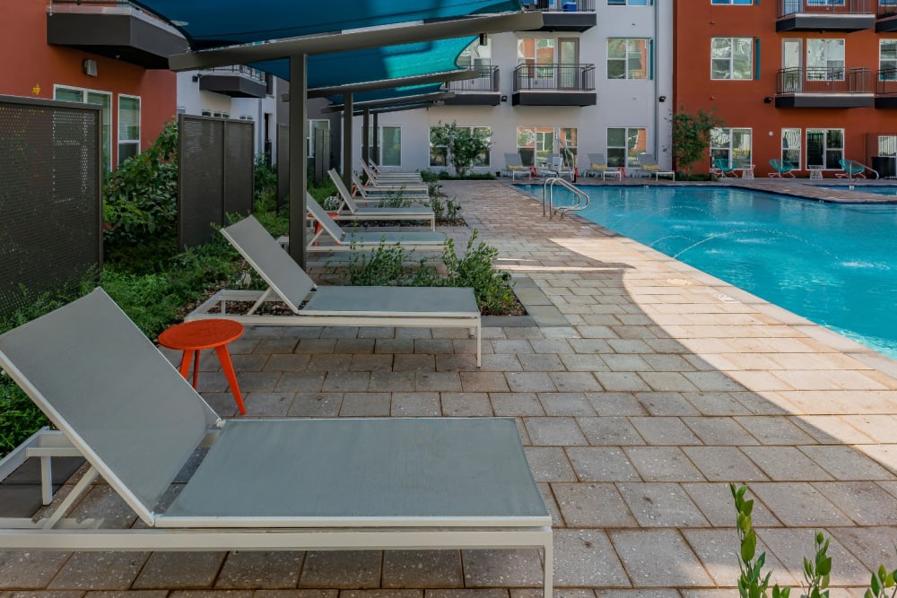 Community lounge chairs with shade at Encore Tessera in Phoenix, Arizona