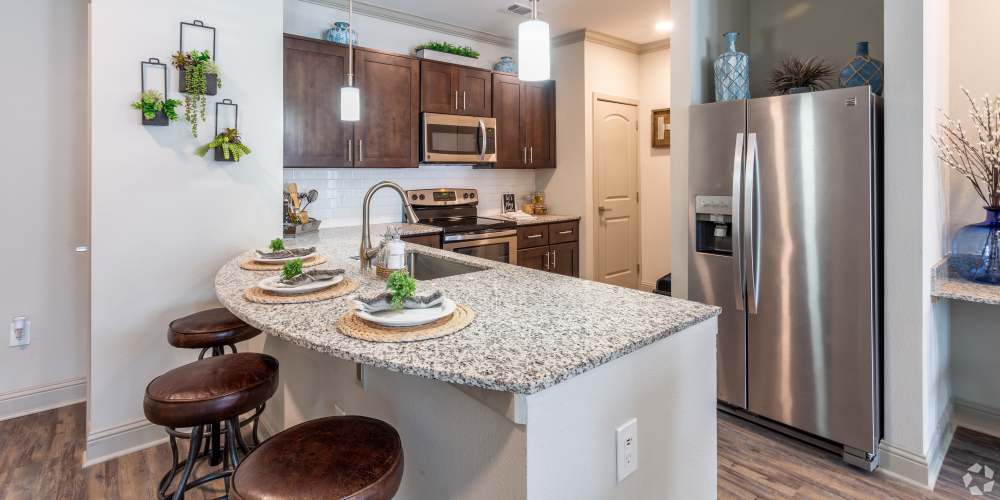 Spacious kitchen with granite counter tops at Caliber at Hyland Village in Westminster, Colorado