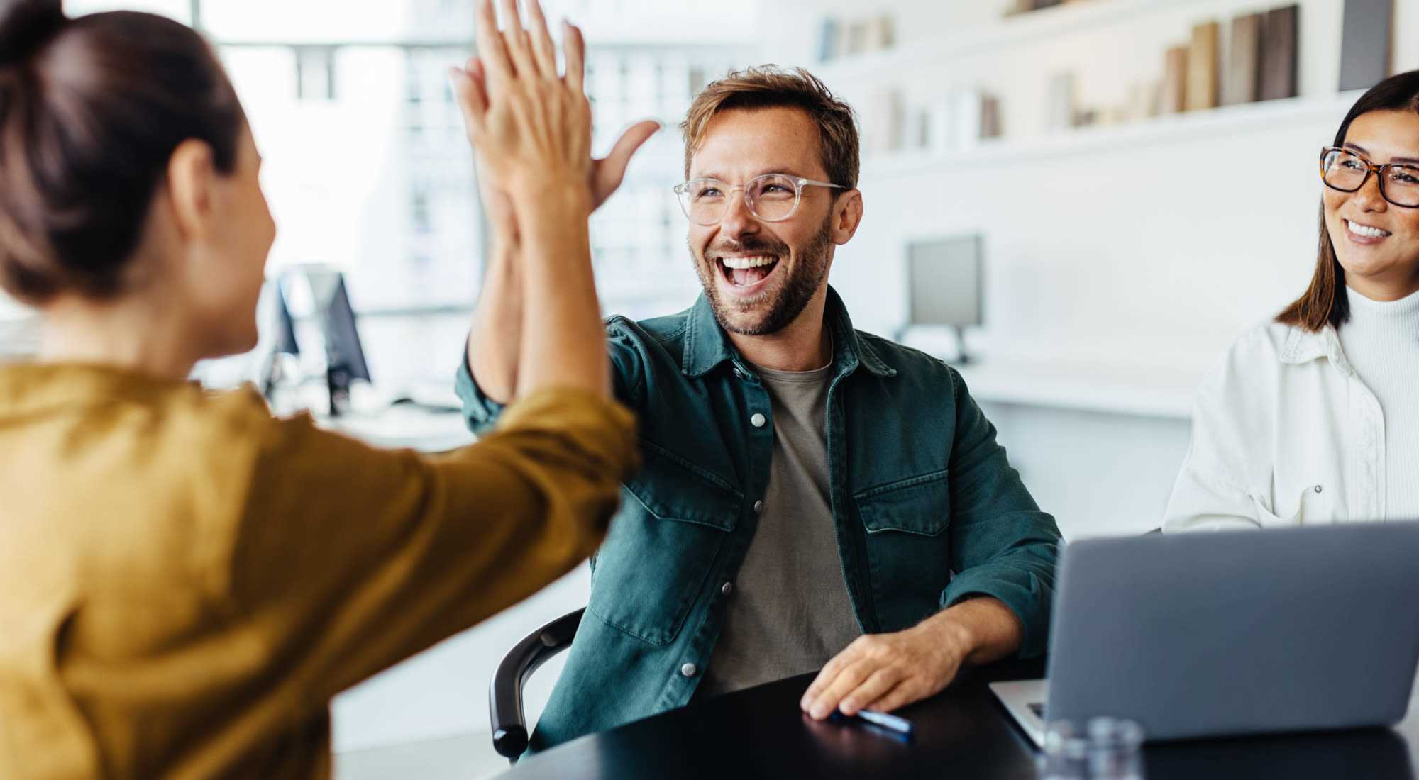 Contact Us | Co-workers doing a high five at Alder Walk in Puyallup, Washington