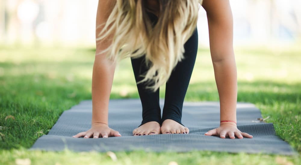 Resident practicing yoga in a park near Eight Mile House in Stockton, California