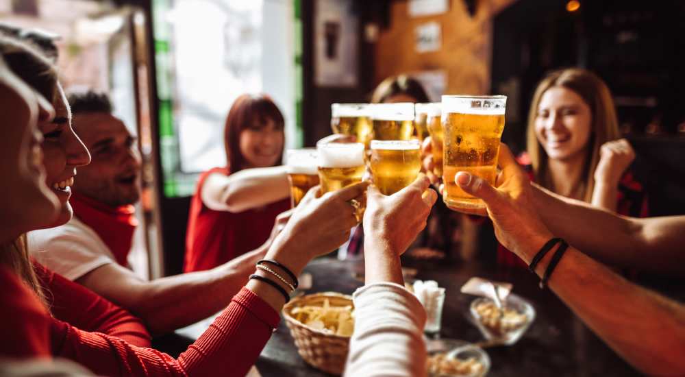 A group of friends toasting their glasses at restaurant near Skyline Flats in Nashville, Tennessee