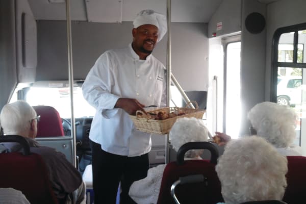 A chef handing out food to residents on the bus at Scholl Canyon Estates in Glendale, California