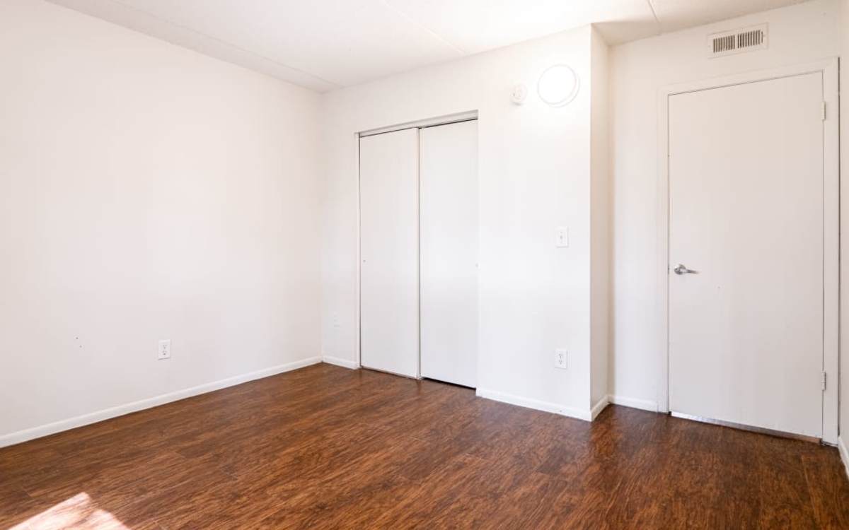 Apartment bedroom with closets at Caroline Arms in Jacksonville, Florida