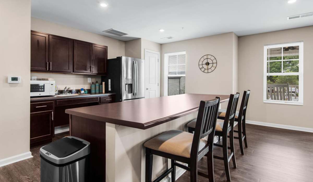 Community kitchen with bar counter and bar stools at Center Crossing in Hickory, North Carolina
