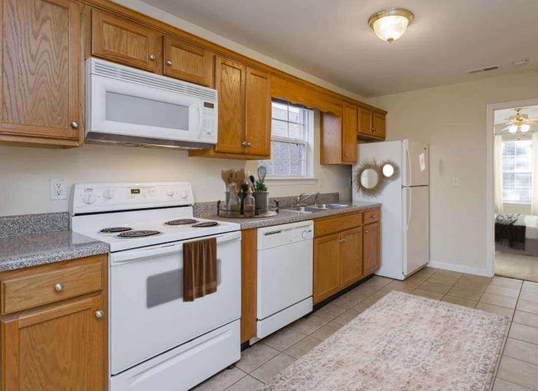 Kitchen with wood cabinets at Home Place Apartments in East Ridge, Tennessee