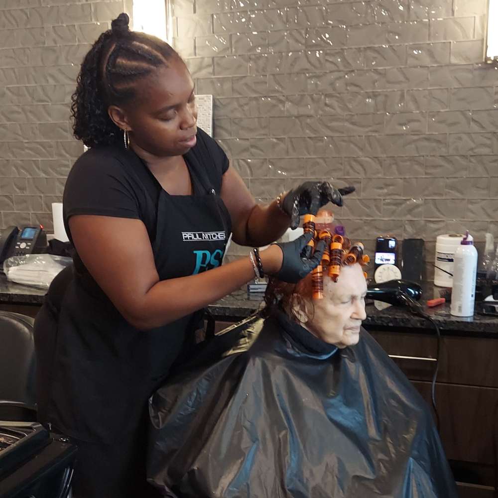 Resident receiving a perm treatment in the salon at The Landing at Shadow Creek Ranch in Texas, enjoying professional hair care.